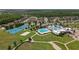 An aerial image displays a neighborhood center with sports courts, pools, and clubhouse with ample parking at 22489 Storybook Cabin Way, Land O Lakes, FL 34637