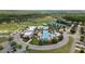 An aerial view of a pool, clubhouse, tennis courts, and playground in a planned community at 22489 Storybook Cabin Way, Land O Lakes, FL 34637
