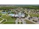 Aerial view of a resort-style community pool, clubhouse, and meticulously landscaped grounds at 22489 Storybook Cabin Way, Land O Lakes, FL 34637