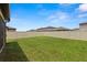 The property includes a large, well-kept lawn and a white vinyl privacy fence at 22489 Storybook Cabin Way, Land O Lakes, FL 34637