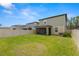 This house has a well-maintained lawn, a screened-in patio, and a vinyl privacy fence at 22489 Storybook Cabin Way, Land O Lakes, FL 34637