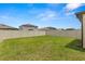 The home's backyard features a well-maintained lawn and a white vinyl privacy fence at 22489 Storybook Cabin Way, Land O Lakes, FL 34637