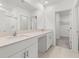 Bathroom featuring double sinks and walk-in closet access at 22489 Storybook Cabin Way, Land O Lakes, FL 34637
