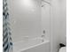 Bathroom featuring a shower-tub combo with subway tiles and modern fixtures at 22489 Storybook Cabin Way, Land O Lakes, FL 34637