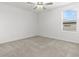 Neutral bedroom with carpet, ceiling fan and a window for natural light at 22489 Storybook Cabin Way, Land O Lakes, FL 34637
