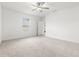 Well-lit bedroom featuring a ceiling fan and ensuite bathroom access at 22489 Storybook Cabin Way, Land O Lakes, FL 34637