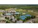 An aerial view of a community center offering pools, tennis courts, a volleyball court, and a picnic area at 22489 Storybook Cabin Way, Land O Lakes, FL 34637