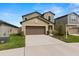 Two-story home with a long driveway, two-car garage, and easy to maintain landscaping at 22489 Storybook Cabin Way, Land O Lakes, FL 34637