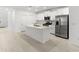 Bright kitchen featuring stainless steel appliances, an island and white cabinetry at 22489 Storybook Cabin Way, Land O Lakes, FL 34637