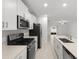 Modern kitchen featuring stainless steel appliances, white cabinets, and granite countertops at 22489 Storybook Cabin Way, Land O Lakes, FL 34637