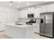 Modern kitchen featuring stainless steel appliances, an island and white cabinetry at 22489 Storybook Cabin Way, Land O Lakes, FL 34637