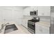 Kitchen with stainless steel appliances, modern cabinetry and countertops, and tile floors at 22489 Storybook Cabin Way, Land O Lakes, FL 34637