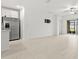 Spacious living room open to kitchen with tile floors and sliding glass doors to backyard at 22489 Storybook Cabin Way, Land O Lakes, FL 34637
