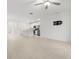 Open concept living space featuring tile floors and view of kitchen with white cabinets at 22489 Storybook Cabin Way, Land O Lakes, FL 34637