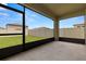 A screened in patio overlooks a well-maintained lawn and white vinyl fence at 22489 Storybook Cabin Way, Land O Lakes, FL 34637