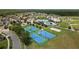 Aerial view of the community center featuring tennis courts, a volleyball court, and a splashpad at 22489 Storybook Cabin Way, Land O Lakes, FL 34637