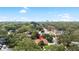 Aerial view of the property surrounded by mature trees, showcasing the neighborhood at 2306 S San Jose Cir, Tampa, FL 33629
