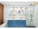 Bathroom features a double sink vanity, round mirrors, and a glass shower at 2306 S San Jose Cir, Tampa, FL 33629