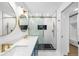 Bathroom featuring a double sink vanity and shower with black and white tile at 2306 S San Jose Cir, Tampa, FL 33629