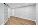 Bright bedroom with wood-look floors and sliding barn door showcasing the interior at 2306 S San Jose Cir, Tampa, FL 33629