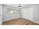 Bedroom with wood-look tile floors, a large window, and a closet at 2306 S San Jose Cir, Tampa, FL 33629