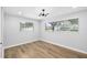 Sunlit bedroom with wood floors and neutral tones features dual windows and recessed lighting at 2306 S San Jose Cir, Tampa, FL 33629