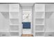 Spacious walk-in closet with custom shelving and a glimpse into the ensuite bathroom at 2306 S San Jose Cir, Tampa, FL 33629