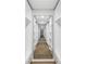 Walk-in closet with custom shelving along a long hallway at 2306 S San Jose Cir, Tampa, FL 33629