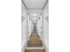Walk-in closet with custom shelving along a long hallway at 2306 S San Jose Cir, Tampa, FL 33629
