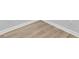 Close up of wood-look tile flooring with baseboard at 2306 S San Jose Cir, Tampa, FL 33629
