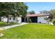 Well-maintained lawn and modern exterior with black and white accents, plus updated landscaping at 2306 S San Jose Cir, Tampa, FL 33629