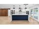 Modern kitchen with white cabinets, stainless steel appliances, a large island, and sliding door to a pool at 2306 S San Jose Cir, Tampa, FL 33629