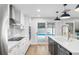 Bright kitchen with white cabinets, modern appliances, stylish pendant lights, and pool views at 2306 S San Jose Cir, Tampa, FL 33629