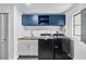 Updated laundry room featuring blue cabinets and new washer and dryer at 2306 S San Jose Cir, Tampa, FL 33629