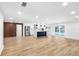 Bright, open-concept living space with wood-look tile flooring, island kitchen, and lots of sunlight at 2306 S San Jose Cir, Tampa, FL 33629