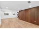 Spacious living room with wood-look tile flooring, modern wood wall feature, and natural light at 2306 S San Jose Cir, Tampa, FL 33629