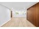 Bright living room featuring wood-look tile, a decorative wood wall, and ample natural light from windows at 2306 S San Jose Cir, Tampa, FL 33629