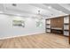Living area with modern wood accent wall, decorative shelving, fireplace, recessed lighting, and wood-look tile floors at 2306 S San Jose Cir, Tampa, FL 33629