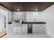 Outdoor kitchen with stainless steel grill, beverage cooler, and stone accents for stylish outdoor dining at 2306 S San Jose Cir, Tampa, FL 33629