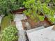 This aerial backyard shot displays a fenced yard, a concrete patio, and mature trees at 2312 Highland S St, St Petersburg, FL 33705