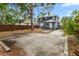 Exterior view of a home with a wooden fence and a concrete parking area at 2312 Highland S St, St Petersburg, FL 33705
