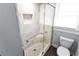 Bathroom featuring a glass shower with tile surround and mosaic tile shelf at 2312 Highland S St, St Petersburg, FL 33705