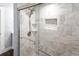 Glass shower featuring a shower head and mosaic tile shelf and trim at 2312 Highland S St, St Petersburg, FL 33705