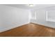 Sunny bedroom featuring hardwood floors, a window, and baseboard trim at 2312 Highland S St, St Petersburg, FL 33705