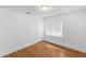 Bright bedroom with wood floors features white walls and trim, one window, and a closet door at 2312 Highland S St, St Petersburg, FL 33705