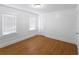 Cozy bedroom with two windows and hardwood flooring providing natural light at 2312 Highland S St, St Petersburg, FL 33705