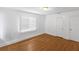 Well-lit bedroom with hardwood floors featuring two doors and bright sunlight at 2312 Highland S St, St Petersburg, FL 33705
