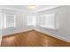 Sun-filled bedroom featuring hardwood floors and windows with bright sunlight at 2312 Highland S St, St Petersburg, FL 33705