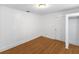 Bright bedroom features white walls and trim, wood floors, one window with blinds, and a closet at 2312 Highland S St, St Petersburg, FL 33705