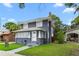 Inviting two-story home with a gray exterior, white trim, and manicured lawn at 2312 Highland S St, St Petersburg, FL 33705